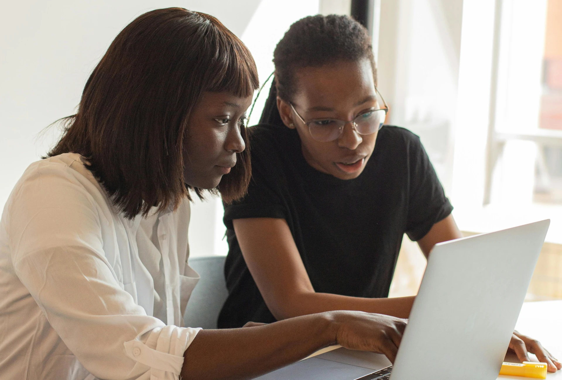 Women working collaboratively on a computer